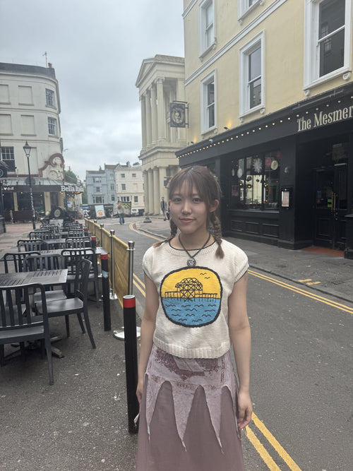Customer wearing a crochet-applique tee on a Brighton street