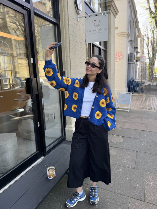 Customer photo outside the Ana Chic Brighton shop in a sunflower cardigan