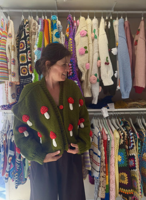 Customer in a green mushroom cardigan inside the Brighton shop