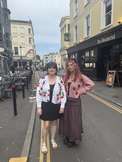 Two customers in handmade cardigans on a Brighton street