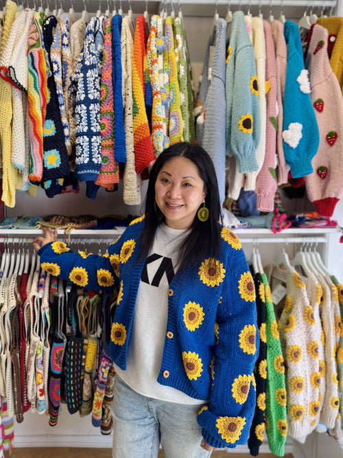 Customer in a blue sunflower cardigan at the Brighton shop