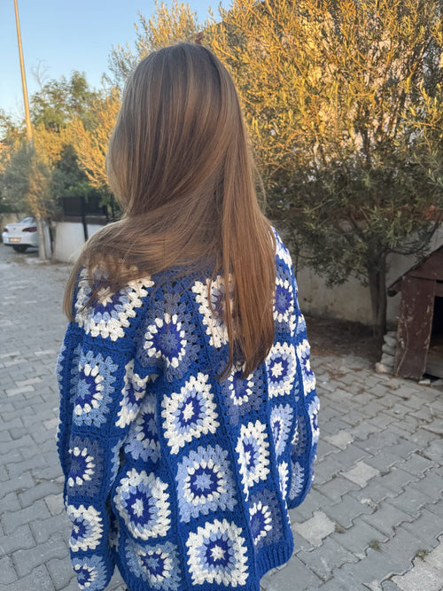 Back view of a customer in a blue granny-square cardigan