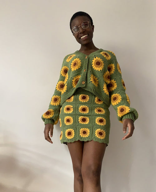 Customer in a green sunflower cardigan and skirt set