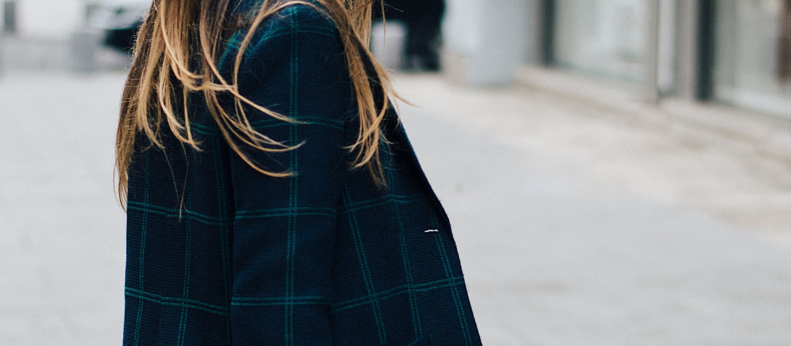 Woman in knitwear cardigan walking outdoors - seasonal styling inspiration