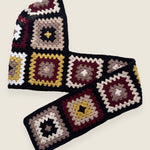 Black granny-square crochet hooded scarf laid flat, hood and long scarf in one piece — handmade by Ana Chic