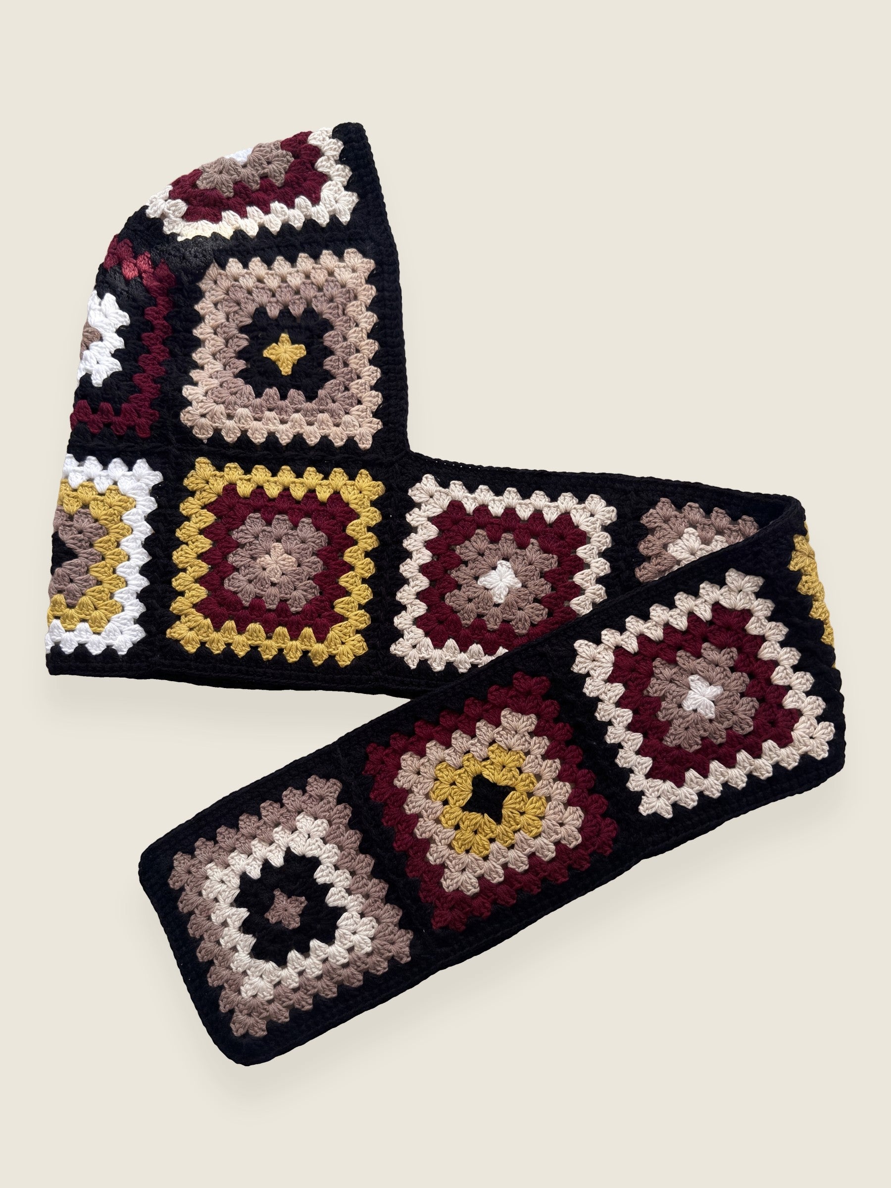 Black granny-square crochet hooded scarf laid flat, hood and long scarf in one piece — handmade by Ana Chic