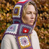 Plum granny-square crochet hooded scarf worn with the hood up and the tails down the front — handmade by Ana Chic