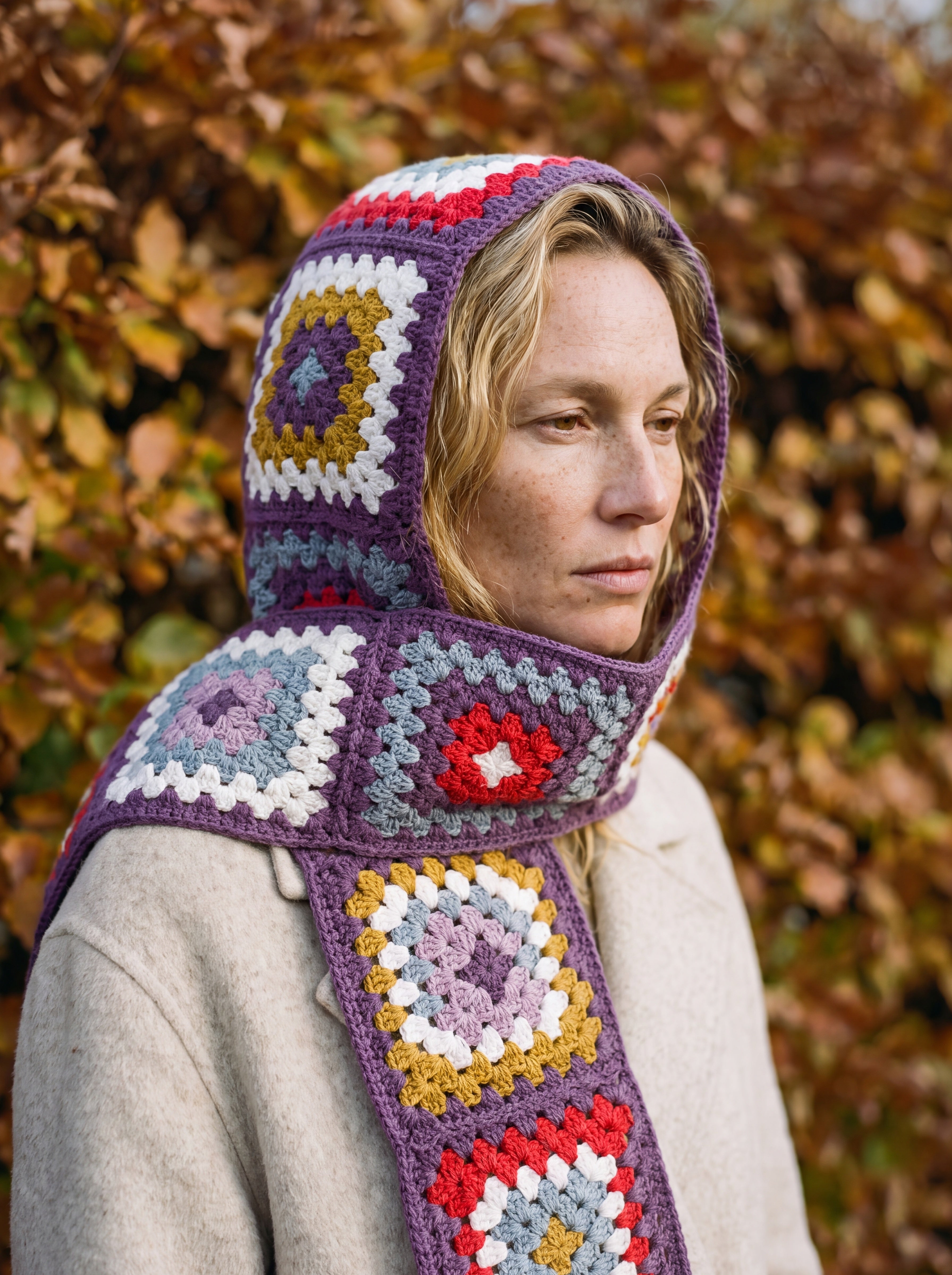 Plum granny-square crochet hooded scarf worn with the hood up and the tails down the front — handmade by Ana Chic
