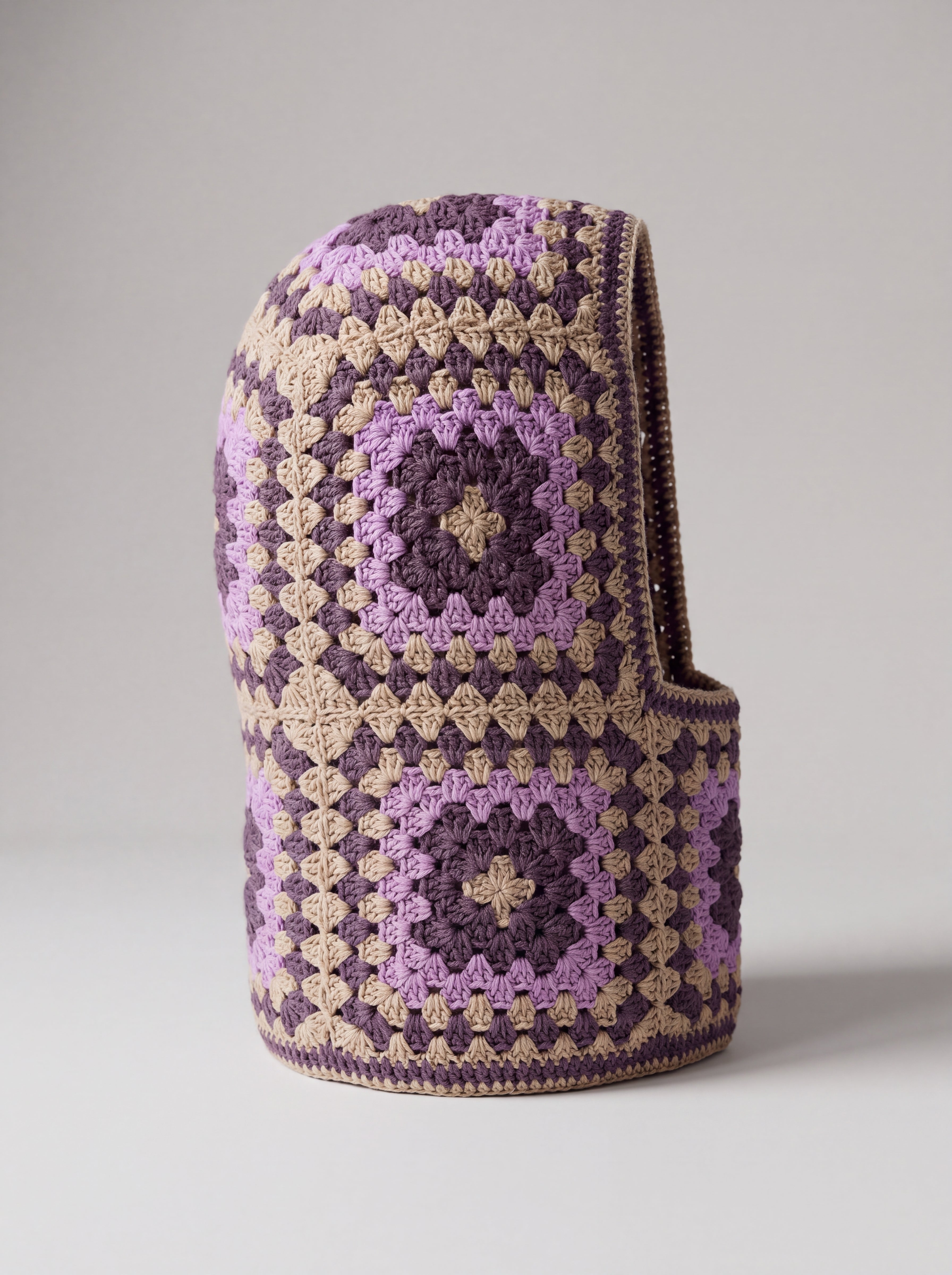 Sand and plum granny square balaclava standing on its own, back view of the hood — handmade by Ana Chic
