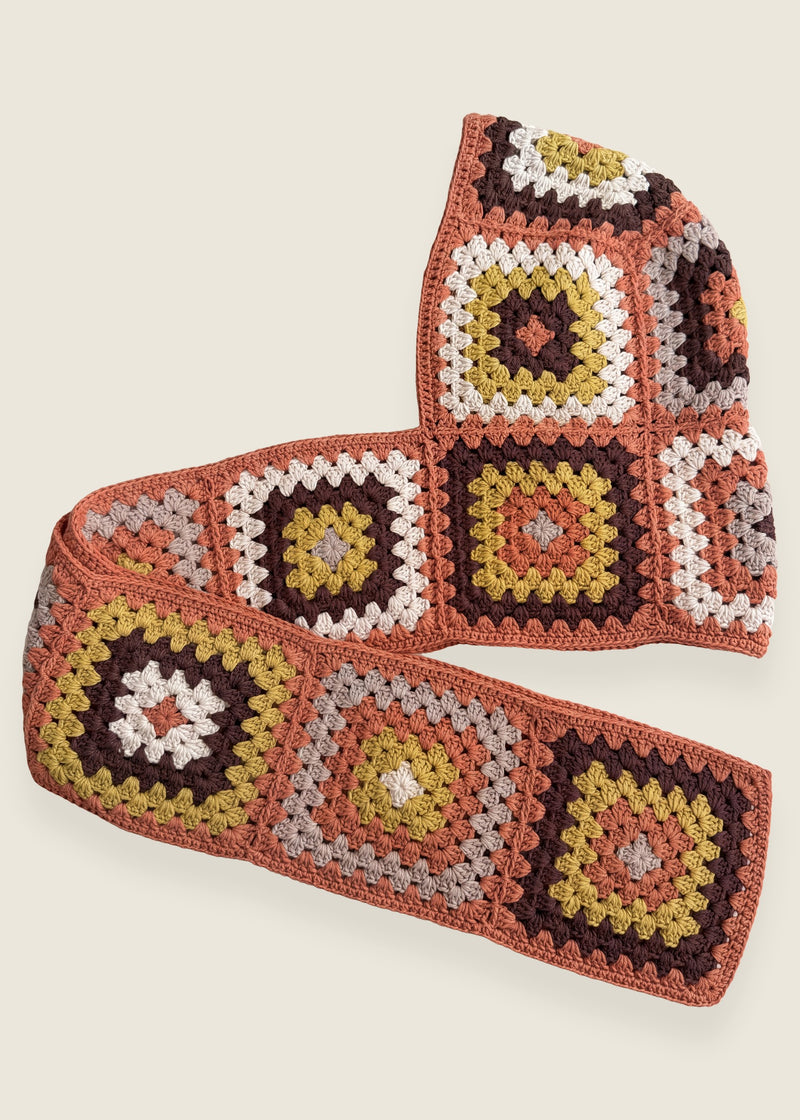 Terracotta granny-square crochet hooded scarf laid flat, hood and long scarf in one piece — handmade by Ana Chic