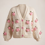 Rose Cream cardigan front — cream chunky hand-knitted wool cardigan with crocheted pink roses and pink buttons, handmade by Ana Chic