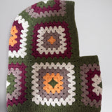 Olive green granny square balaclava laid flat, side view of the hood — handmade by Ana Chic