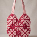 Back of the pink crochet shoulder bag with its daisy granny squares and pink shoulder straps — handmade by Ana Chic