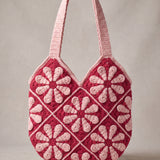 Back of the pink crochet shoulder bag with its daisy granny squares and pink shoulder straps — handmade by Ana Chic
