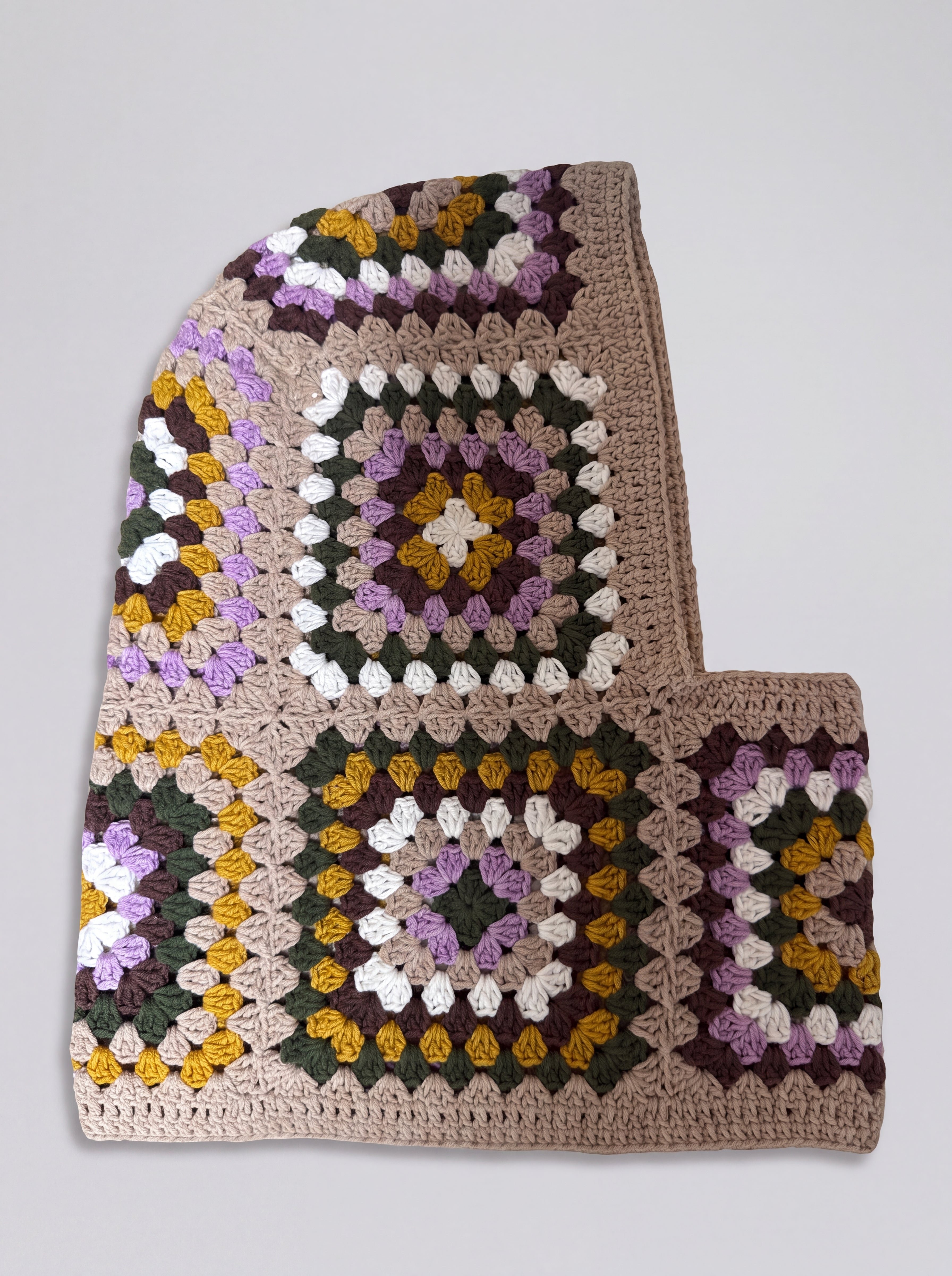Sand and lilac granny square balaclava laid flat, side view of the hood — handmade by Ana Chic