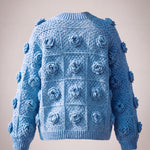 Back of the cornflower blue rose granny square cardigan with ribbed hem and cuffs — handmade by Ana Chic