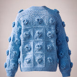 Back of the cornflower blue rose granny square cardigan with ribbed hem and cuffs — handmade by Ana Chic