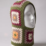 Olive green granny square balaclava on a display head, open face and deep neck section — handmade by Ana Chic