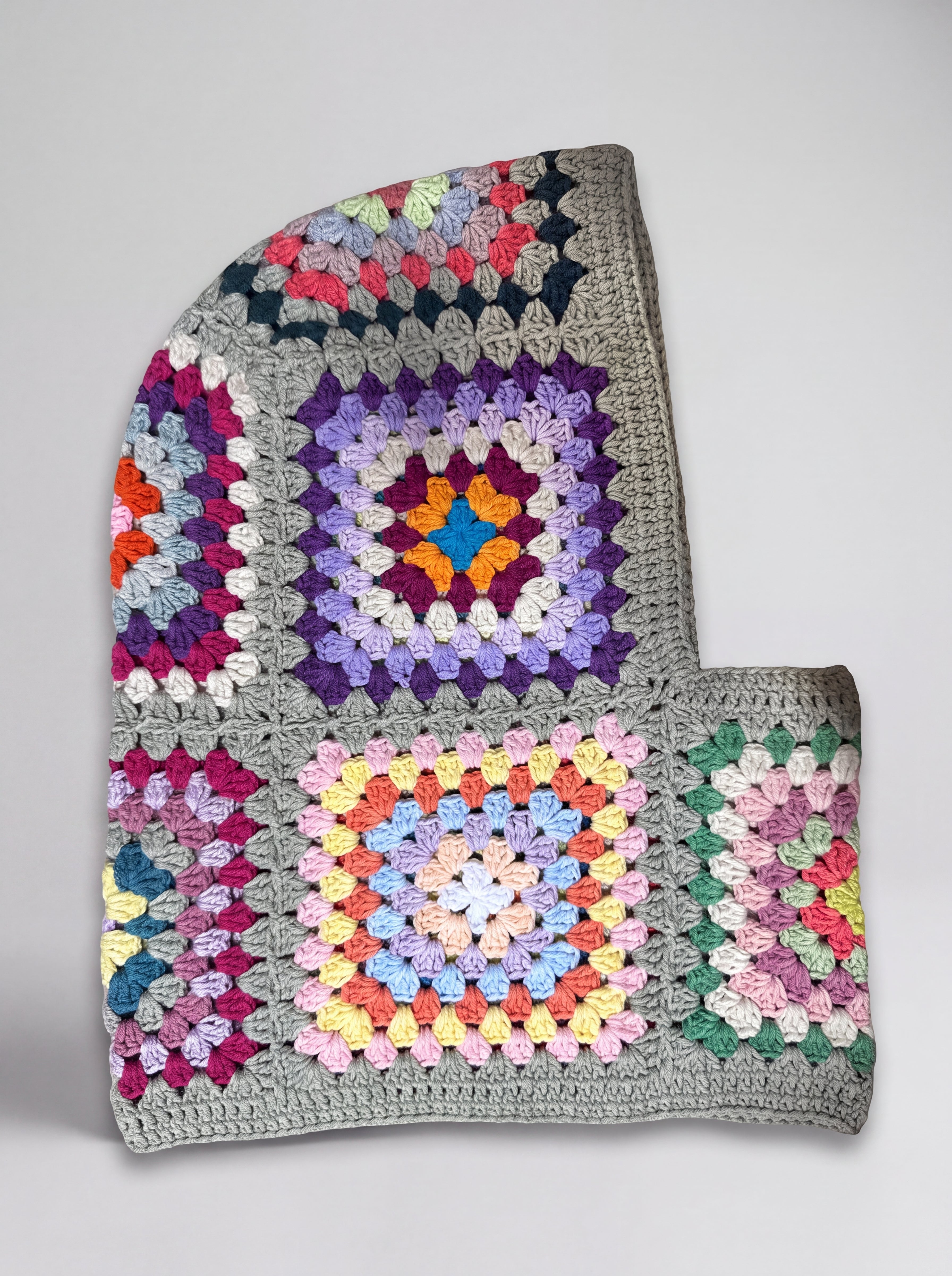 Sage multicolour granny square balaclava laid flat, side view of the hood — handmade by Ana Chic