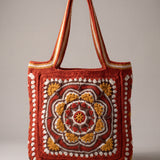 Front of the rust crochet tote bag with its raised crocheted medallion — handmade by Ana Chic