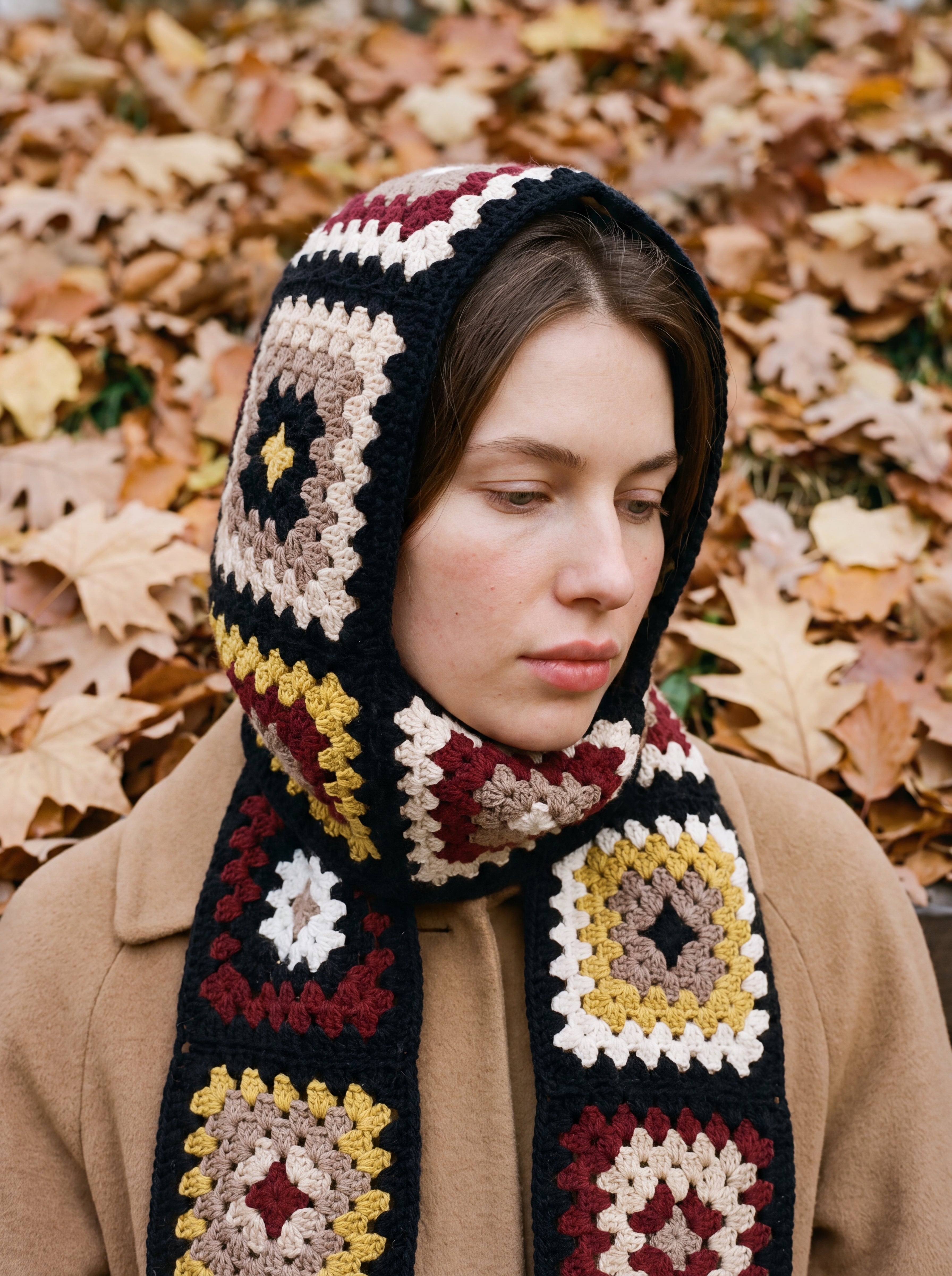 Black granny-square crochet hooded scarf worn with the hood up and the tails down the front — handmade by Ana Chic