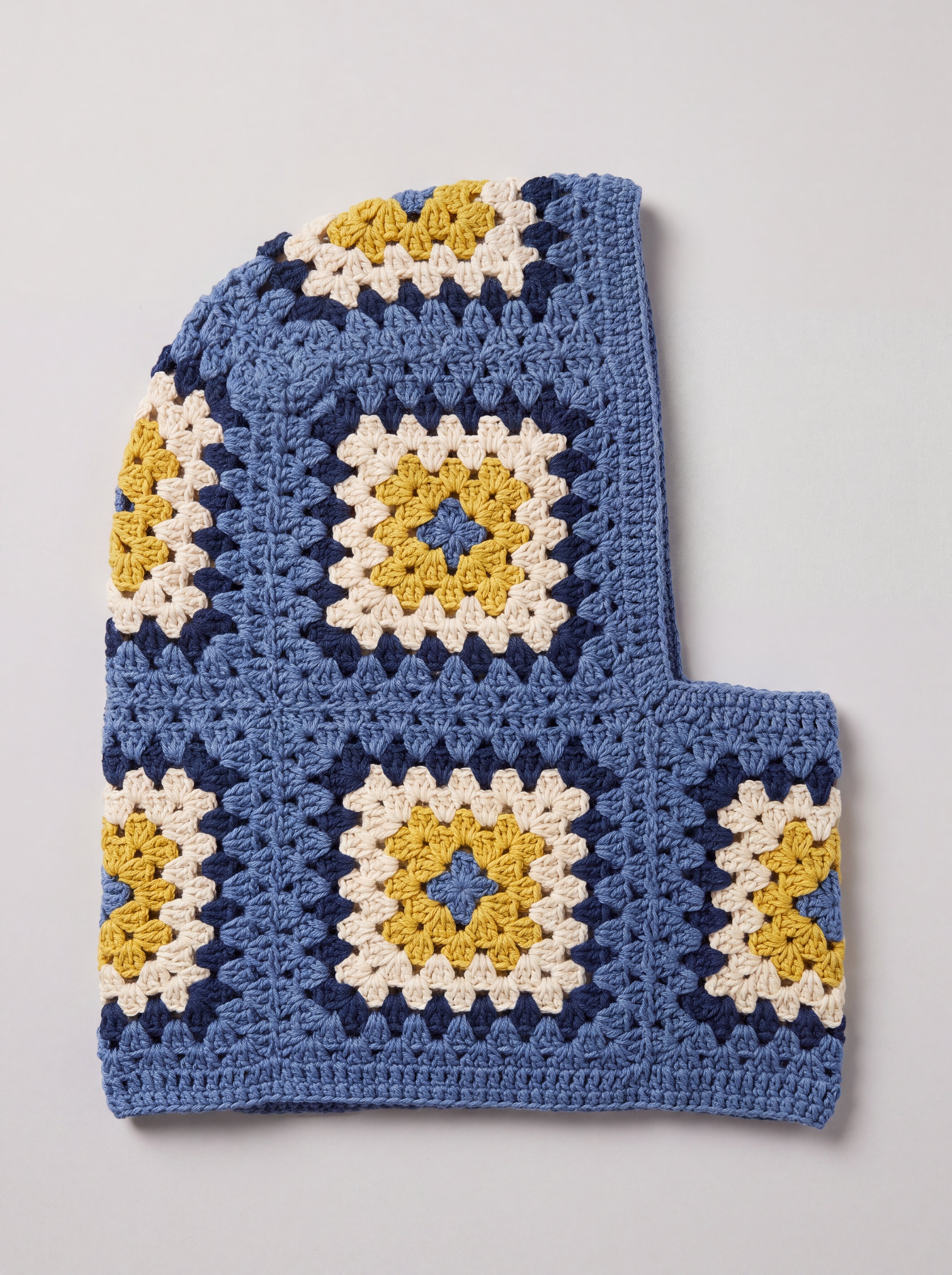 Denim blue and mustard granny square balaclava laid flat, side view of the hood — handmade by Ana Chic