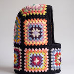 Black pastel granny square balaclava standing on its own, back view of the hood — handmade by Ana Chic