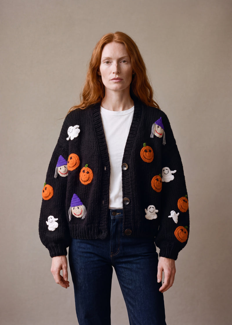 Halloween - black chunky hand-knitted wool cardigan with crocheted motifs, worn open over a plain top by Ana Chic