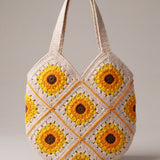 Front of the cream crochet shoulder bag with sunflower granny squares, orange seams and two wide straps — handmade by Ana Chic