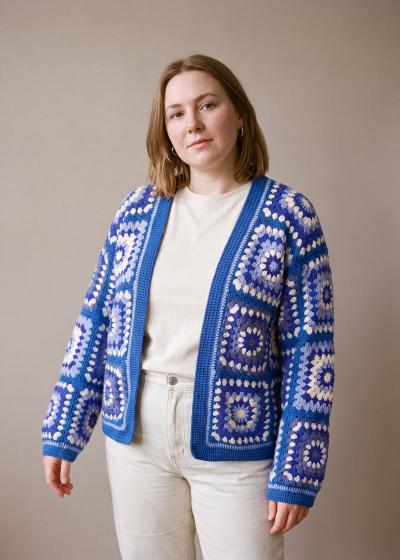 Handmade organic cotton crochet cardigan by Ana Chic worn open over a cream tee