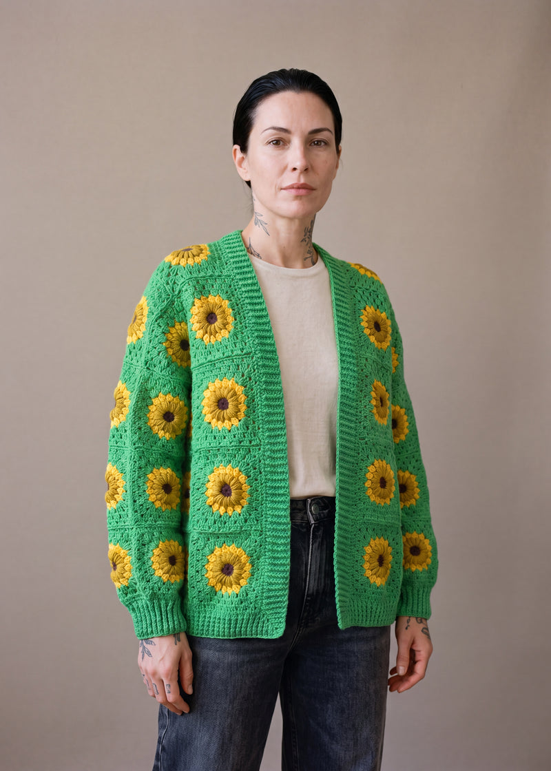 Green Sunflower Cardigan - Bright grass green crocheted granny square cardigan with raised crochet sunflowers, worn by Ana Chic
