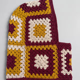 Burgundy and mustard granny square balaclava laid flat, side view of the hood — handmade by Ana Chic