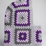 Grey and purple granny square balaclava laid flat, side view of the hood — handmade by Ana Chic