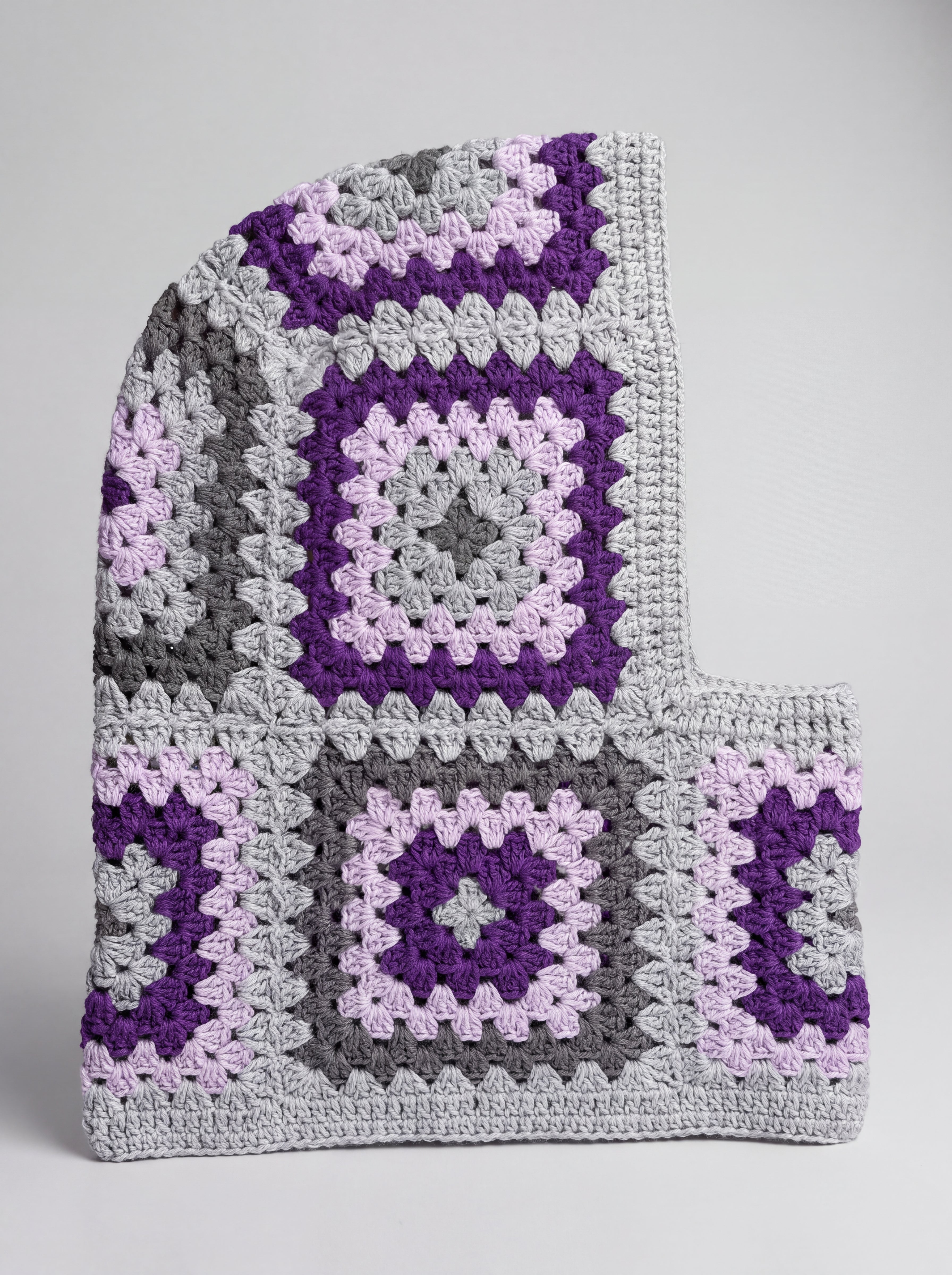 Grey and purple granny square balaclava laid flat, side view of the hood — handmade by Ana Chic