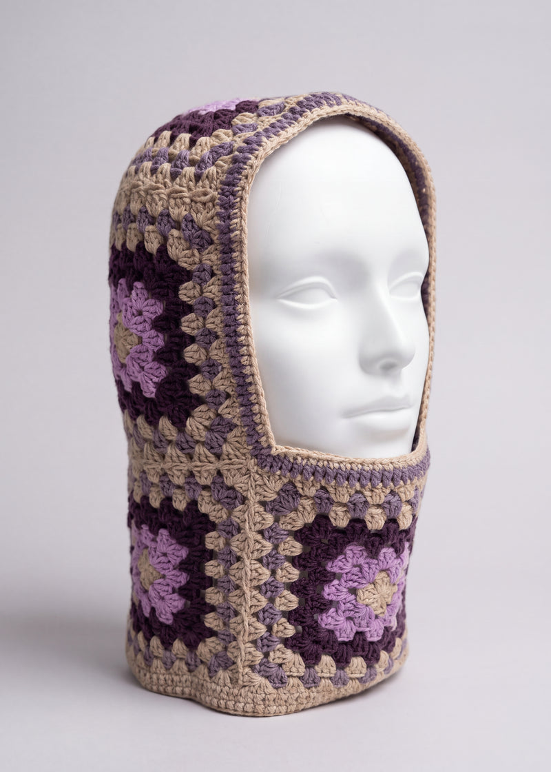 Sand and plum granny square balaclava on a display head, open face and deep neck section — handmade by Ana Chic