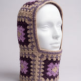 Sand and plum granny square balaclava on a display head, open face and deep neck section — handmade by Ana Chic