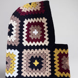 Black and burgundy granny square balaclava laid flat, side view of the hood — handmade by Ana Chic