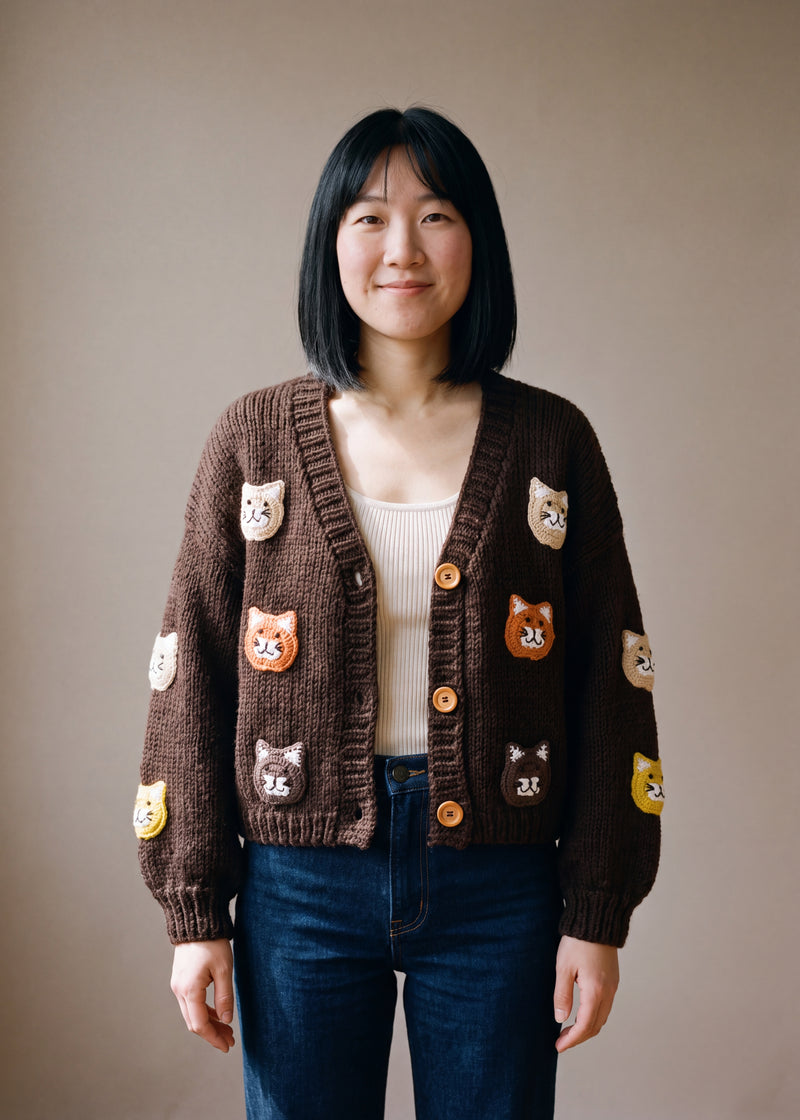 Brown cat cardigan - dark chocolate brown chunky hand-knitted wool cardigan with crocheted motifs, worn open over a plain top by Ana Chic