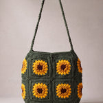 Back of the dark green crochet crossbody bag with its sunflower squares and adjustable strap — handmade by Ana Chic