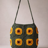 Back of the dark green crochet crossbody bag with its sunflower squares and adjustable strap — handmade by Ana Chic