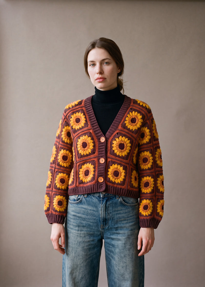 Crop Sunflower Cardigan - Rust and Chocolate - Rust/terracotta square grounds crocheted granny square cardigan with raised crochet sunflowers, worn by Ana Chic