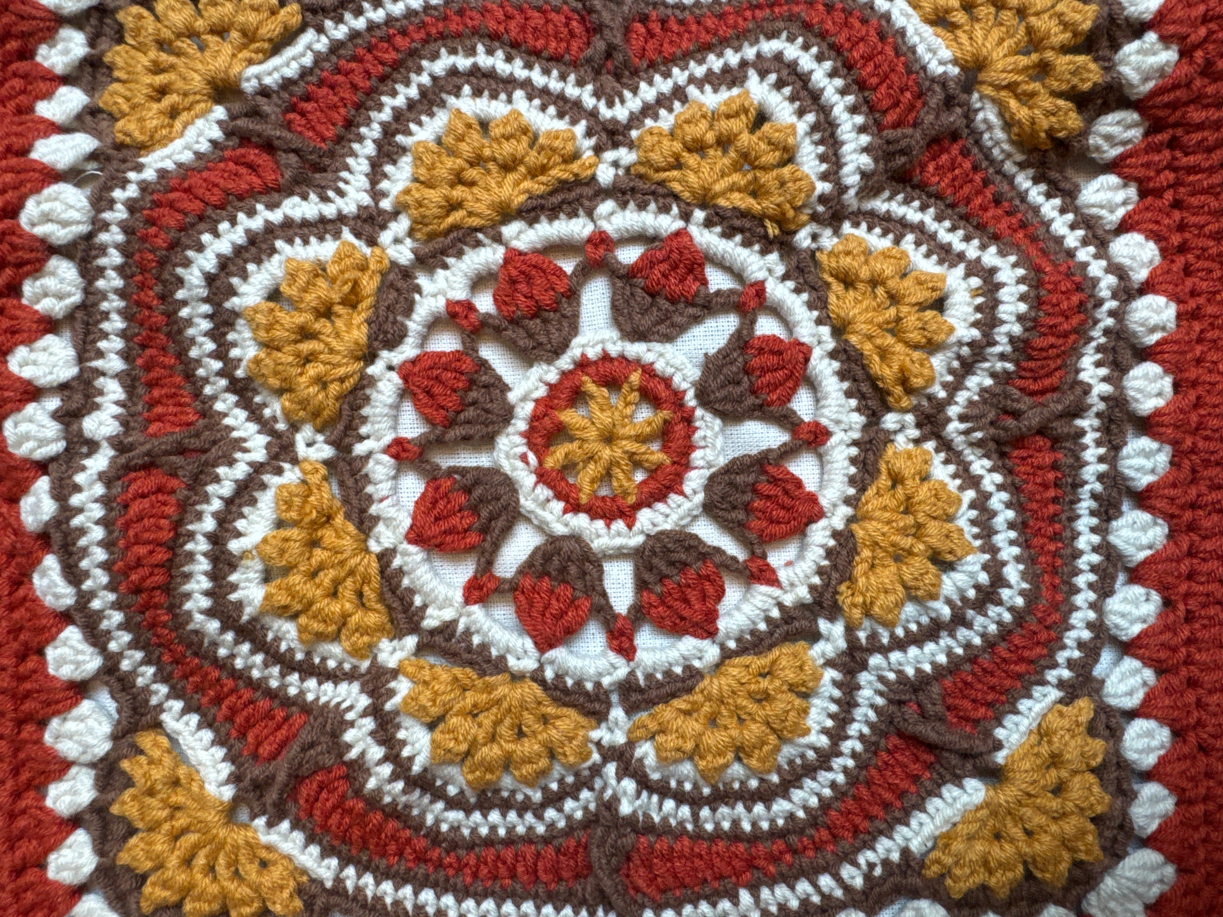 Close-up of the crocheted medallion on the rust crochet tote bag — handmade by Ana Chic