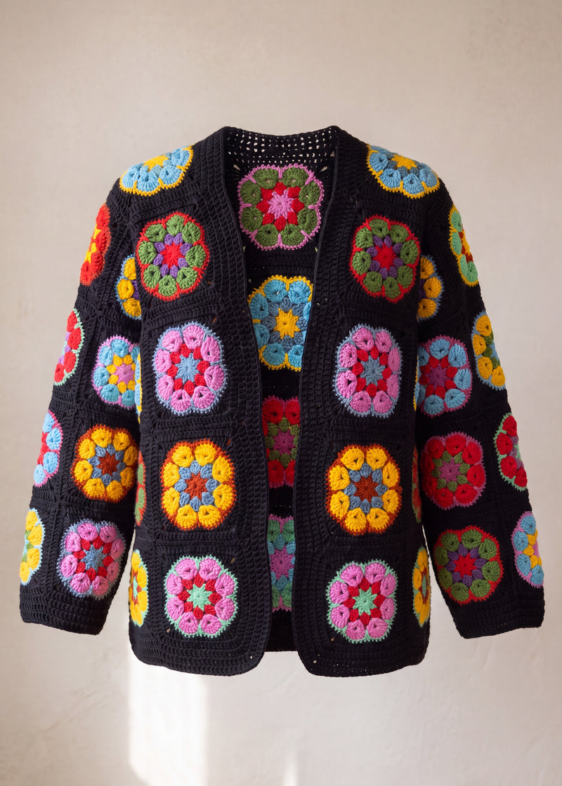 Black crochet cardigan with hexagonal African-flower blocks in pink, yellow, red and blue, front view - handmade by Ana Chic