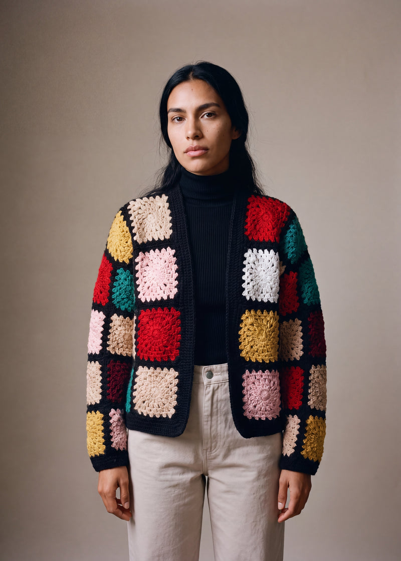 Wool Granny - black chunky hand-knitted wool cardigan with crocheted motifs, worn open over a plain top by Ana Chic