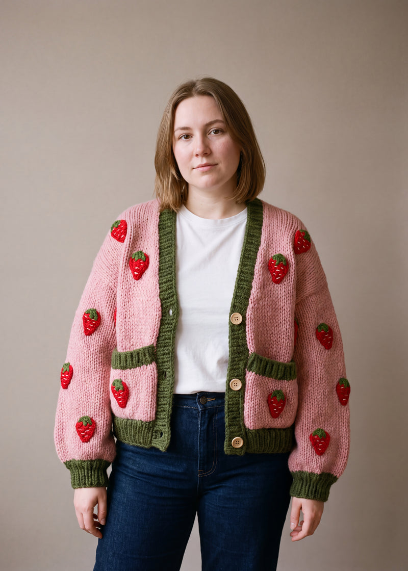 Strawberry Hand Knitted Cardigan - soft pink body chunky hand-knitted wool cardigan with crocheted motifs, worn open over a plain top by Ana Chic