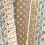 Close-up of the open front edge of an ecru hexagon crochet cardigan, granny clusters and turquoise stripe - handmade by Ana Chic