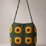 Front of the dark green crochet crossbody bag with four sunflower squares and a long braided strap — handmade by Ana Chic