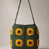 Front of the dark green crochet crossbody bag with four sunflower squares and a long braided strap — handmade by Ana Chic