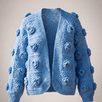 Cornflower blue granny square cardigan with a raised crochet rose on every square, front view — handmade by Ana Chic