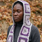 Grey granny-square crochet hooded scarf worn with the hood up and the tails down the front — handmade by Ana Chic